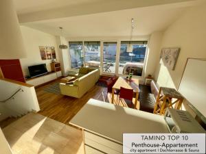 a living room with a couch and a table at Penthouse TAMINO TOP 10 in Schladming