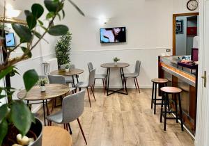 a restaurant with tables and chairs and a tv on the wall at Hotel S. Ercolano in Perugia