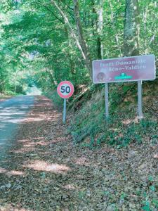 a speed limit sign on the side of a road at Maison dans le bourg in La Chapelle-Montligeon