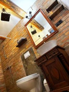 a bathroom with a toilet and a sink and a mirror at Baboško in Rimavská Sobota