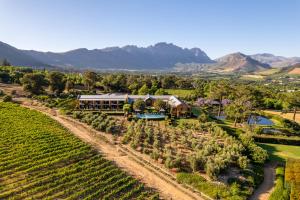 an aerial view of the winery with a vineyard at La Residence in Franschhoek