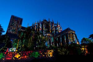 a large building with lights on it at night at La chambre du bosquet in Le Mans