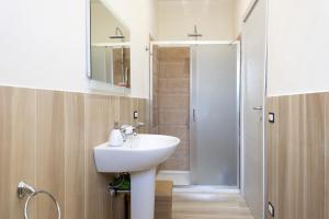 a bathroom with a white sink and a shower at Sefy Mare A Selinunte in Marinella di Selinunte