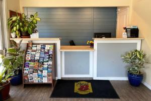 a counter in a store with plants in a room at Super 8 by Wyndham Red Bluff in Red Bluff