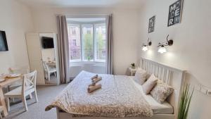 a bedroom with a bed with a teddy bear on it at Finnem Rentals Zíkova in Prague