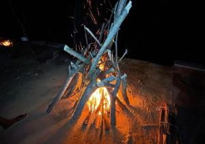 a fire pit in the ground at night at Ella Camping Resort in Ella