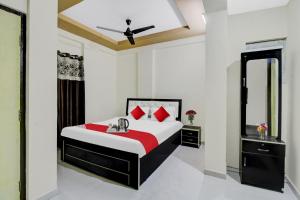 a bedroom with a bed and a mirror at Flagship Ap Royal Rooms in Nagpur
