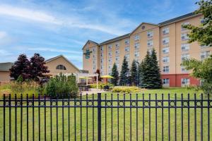 a view of a hotel from behind a fence at Homewood Suites by Hilton Toronto-Oakville in Oakville