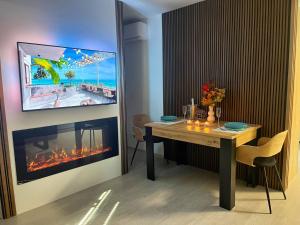 a dining room with a table and a fireplace at Apartamenty Lumax in Gryfice +44 photos