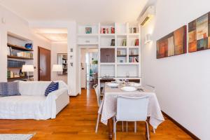 a living room with a white couch and a table at Vodice Flexyrent apartment in Milan