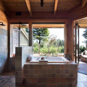 a bath tub in a room with a large window at Alila Ventana Big Sur Adult Only in Big Sur
