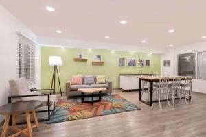 a living room with a couch and a table and chairs at WoodSpring Suites Savannah Pooler in Savannah