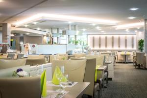 a dining room with white tables and chairs at Hotel Frankenland in Bad Kissingen