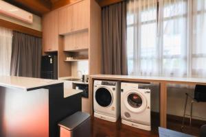 une cuisine équipée d'un lave-linge et d'un lave-linge/sèche-linge. dans l'établissement Chamber’ 64 private pool villa, à Chiang Mai