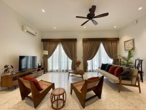 ein Wohnzimmer mit einem Sofa und einem TV in der Unterkunft Third Aunt's Place in Malakka