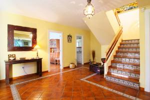 a living room with a staircase and a table at Villa La Palmera in Mortera