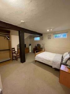 a bedroom with a bed and a desk and a chair at The Old Hay Barn - Games Room, Gym, Sleeps 8 in Godmanchester