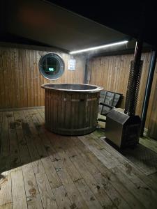 a bath tub in a room with a wooden floor at Humberston Boathouse Lodges with Hot Tub - Cleethorpes Beach Cabin Chalet in Humberston