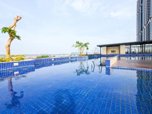 a large pool with blue tiles on the side of a building at lovina 1115 at Pollux Meisterstadt in Batam Center