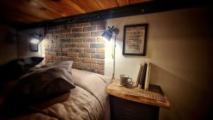 a bedroom with a bed and a brick wall at Casa22 in Abbadia San Salvatore