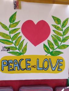 a sign with a heart and peace and love at Bob Marley Peace hostels luxor in Luxor