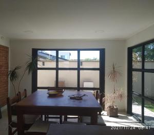 a dining room with a table and a large window at Casa D a 2 - Con Parrilla - Centro de Federación in Federación +12 photos