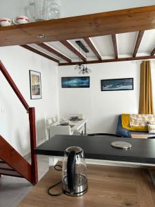 a room with a black table and a couch at La Maisonnette in Les Pieux