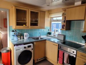 a small kitchen with a sink and a dishwasher at No 27 Guisborough - 1 bed apartment in Guisborough