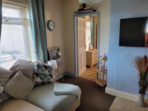 a living room with a couch and a tv at No 27 Guisborough - 1 bed apartment in Guisborough