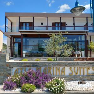 a building with a sign in front of it at Ayia Marina Suites in Ouranoupoli