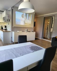 a living room with a table and a projection screen at The entire comfortable apartment in Rakvere