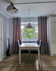a dining room table with chairs and a window at The entire comfortable apartment in Rakvere