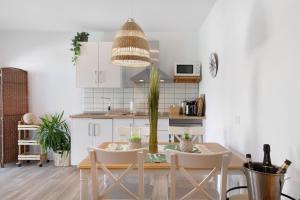 a kitchen with a table with a potted plant at Villa Tino- Casa D in Los Llanos de Aridane