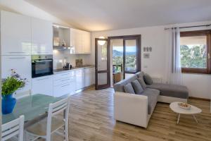 a kitchen and living room with a couch and a table at Villa Aloe in Costa Paradiso