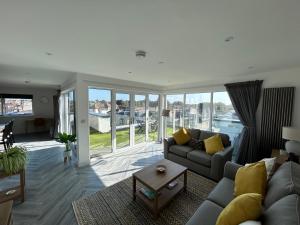 a living room with a couch and a table at Cathedral Views in Chichester