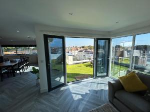 a living room with large windows and a couch at Cathedral Views in Chichester