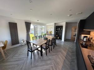 a kitchen and dining room with a wooden table and chairs at Cathedral Views in Chichester