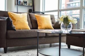 a living room with a couch and a table with yellow pillows at The Splendid - Luxury 1BR Uptown Toronto in Toronto
