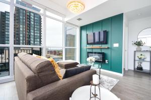 a living room with a couch and a tv at The Splendid - Luxury 1BR Uptown Toronto in Toronto