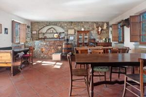 a kitchen and dining room with tables and chairs at Casa della Barcareccia in Calice al Cornoviglio