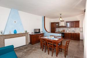 a kitchen with a table and chairs in a room at Casa Irgoli - Sardegna in Irgoli +13 photos