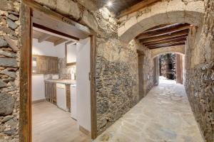 an entrance to a kitchen with a stone wall at Casa Tajinaste in Vilaflor