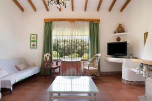 a living room with a couch and a table at Casa Los Alamos in La Muela