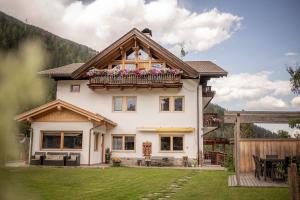 a house with a balcony with flowers on it at Adlerhorst Rotkehlchen in Santa Valburga St. Walburg