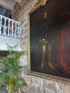 a large painting of a man on a wall at Maison Barón de la Galleta in Quintanilla las Torres