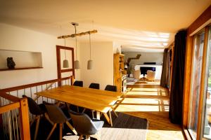 a dining room with a wooden table and chairs at Gartenloft an der Mur in Murau