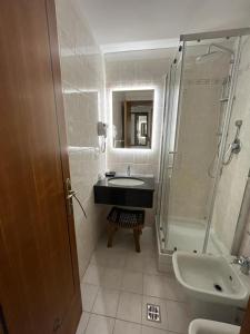 a bathroom with a sink and a shower at AFFITTACAMERE REGIO in Rome