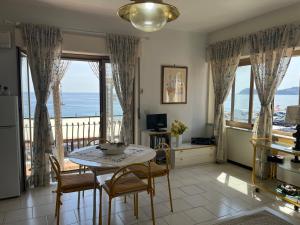 a kitchen and dining room with a table and chairs at Casa del Sole in Letojanni