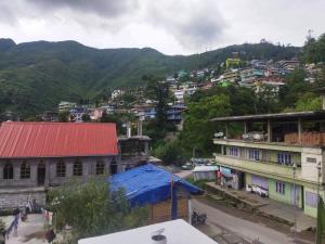 a view of a city with buildings and a mountain at Hotel Nambrog in Bomdila