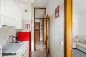 a kitchen with a red refrigerator next to a living room at Kris- Mestre Bright Apartment with Parking! in Mestre